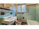 Charming bathroom with vintage fixtures, colorful tiles, and a window at 1606 Orangewood Ave, Orlando, FL 32806