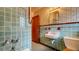 Unique bathroom featuring tiled walls, patterned wallpaper, and vintage fixtures at 1606 Orangewood Ave, Orlando, FL 32806
