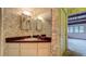 Bathroom featuring a vanity, a mirror, and patterned wallpaper at 1606 Orangewood Ave, Orlando, FL 32806