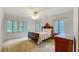 Bright bedroom with vintage furniture and ample natural light from large windows at 1606 Orangewood Ave, Orlando, FL 32806
