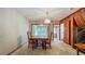 Dining room with dark wood table and chairs, decorative chandelier, and bright natural light at 1606 Orangewood Ave, Orlando, FL 32806