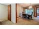 Traditional dining room featuring a carpeted floor, chandelier, and view to the outside at 1606 Orangewood Ave, Orlando, FL 32806