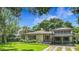 Charming single story home with mature landscaping, porte-cochere, and well-maintained lawn at 1606 Orangewood Ave, Orlando, FL 32806