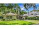 Charming single story home with mature landscaping, porte-cochere, and well-maintained lawn at 1606 Orangewood Ave, Orlando, FL 32806