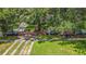 Beautiful tree-lined street with brick and concrete driveway, showcasing the property's curb appeal at 1606 Orangewood Ave, Orlando, FL 32806