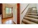 Hallway with staircase and view into a kitchen with a window at 1606 Orangewood Ave, Orlando, FL 32806