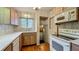 Functional kitchen featuring wood cabinets, updated appliances, and hardwood floors at 1606 Orangewood Ave, Orlando, FL 32806