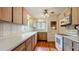 Efficient kitchen with wood cabinets, hardwood floors, and updated appliances at 1606 Orangewood Ave, Orlando, FL 32806