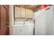 Laundry area with washer and dryer under cabinet, features wood paneled ceiling at 1606 Orangewood Ave, Orlando, FL 32806