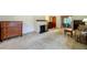 Spacious living room with fireplace, carpet, and open view to the dining area at 1606 Orangewood Ave, Orlando, FL 32806