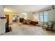 Spacious living room with fireplace, carpet, and windows with natural light at 1606 Orangewood Ave, Orlando, FL 32806