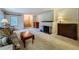 Spacious living room featuring a fireplace, plush carpet, and wood furniture at 1606 Orangewood Ave, Orlando, FL 32806