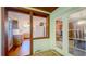 Sunroom view of kitchen, with hardwood floors, wood cabinetry, white appliances, and breakfast nook at 1606 Orangewood Ave, Orlando, FL 32806