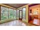Bright sunroom offers lush backyard views and tile flooring at 1606 Orangewood Ave, Orlando, FL 32806