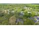 Expansive aerial view of a neighborhood with lush trees, pools, and well-maintained homes at 1689 Wingspan Way, Winter Springs, FL 32708