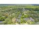 High aerial view showcasing a community surrounded by dense trees and tranquil bodies of water at 1689 Wingspan Way, Winter Springs, FL 32708