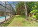 Expansive backyard featuring a screened-in pool at 1689 Wingspan Way, Winter Springs, FL 32708