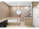 Luxury bathroom with soaking tub, walk-in shower, and elegant finishes at 1689 Wingspan Way, Winter Springs, FL 32708