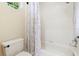 Bright bathroom featuring a shower-tub combo with tiled walls and a decorative shower curtain at 1689 Wingspan Way, Winter Springs, FL 32708