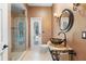 Stylish bathroom with glass bowl sink, decorative fixtures, and a view of the pool outside at 1689 Wingspan Way, Winter Springs, FL 32708