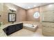 Well-appointed bathroom with soaking tub, walk-in shower, granite counters and luxury finishes at 1689 Wingspan Way, Winter Springs, FL 32708