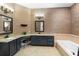 Elegant bathroom features dual vanities, granite countertops, and a luxurious soaking tub at 1689 Wingspan Way, Winter Springs, FL 32708