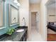 Elegant bathroom with granite countertops, framed mirrors, and white tiled flooring at 1689 Wingspan Way, Winter Springs, FL 32708