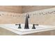 Close-up of modern bathtub with matte black fixtures and neutral tile surround at 1689 Wingspan Way, Winter Springs, FL 32708