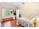 Cozy bedroom with hardwood floors, a window seat, and an attached bathroom at 1689 Wingspan Way, Winter Springs, FL 32708