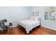 Cozy bedroom with hardwood floors, a comfortable bed, and natural light from the window at 1689 Wingspan Way, Winter Springs, FL 32708