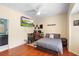 Bedroom with hardwood floors, and setup for a TV or gaming setup at 1689 Wingspan Way, Winter Springs, FL 32708