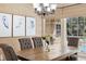 Cozy dining area showcasing a rustic wood table set and a view to the outside at 1689 Wingspan Way, Winter Springs, FL 32708
