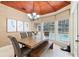 Inviting dining area featuring a wood table, upholstered chairs, and views of the pool at 1689 Wingspan Way, Winter Springs, FL 32708