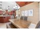 Dining area leading to the kitchen with a wood table and views into the kitchen at 1689 Wingspan Way, Winter Springs, FL 32708