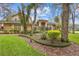 Beautiful two-story home featuring a blue front door and manicured landscaping at 1689 Wingspan Way, Winter Springs, FL 32708