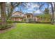 Inviting two-story home with a well-manicured lawn, front shrubs, and a charming blue front door at 1689 Wingspan Way, Winter Springs, FL 32708