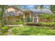 Well-maintained home showcasing a manicured lawn, front shrubs, and an inviting blue front door at 1689 Wingspan Way, Winter Springs, FL 32708