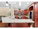 Open concept kitchen with granite countertops, and custom cabinetry at 1689 Wingspan Way, Winter Springs, FL 32708