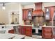 Stylish kitchen featuring an island with granite countertops and stainless steel appliances at 1689 Wingspan Way, Winter Springs, FL 32708