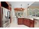 This kitchen features stainless steel appliances, granite countertops, and a connected dining area at 1689 Wingspan Way, Winter Springs, FL 32708