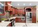 Gourmet kitchen features cherry wood cabinets, granite countertops, and stainless steel appliances at 1689 Wingspan Way, Winter Springs, FL 32708