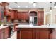 Gourmet kitchen featuring stainless steel appliances, custom cabinets, and granite countertops at 1689 Wingspan Way, Winter Springs, FL 32708