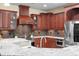 Well-equipped kitchen with custom cabinets, stainless steel appliances, and granite countertops at 1689 Wingspan Way, Winter Springs, FL 32708