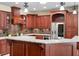 Gourmet kitchen with custom wood cabinets, granite countertops, and stainless steel appliances at 1689 Wingspan Way, Winter Springs, FL 32708