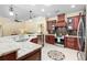 Spacious kitchen with cherry wood cabinets, granite countertops, and stainless steel appliances at 1689 Wingspan Way, Winter Springs, FL 32708