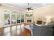 Bright living room features hardwood floors, fireplace, and French doors to the outdoor area with a pool at 1689 Wingspan Way, Winter Springs, FL 32708
