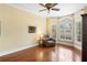 Comfortable sitting area with an armchair, hardwood floors, and large bay windows at 1689 Wingspan Way, Winter Springs, FL 32708