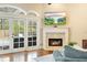 Cozy living room with fireplace and sliding glass doors leading to the pool at 1689 Wingspan Way, Winter Springs, FL 32708