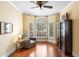 Sitting area with a comfortable armchair, hardwood floors, and bright window lighting at 1689 Wingspan Way, Winter Springs, FL 32708