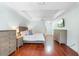 Comfortable main bedroom featuring hardwood floors, tray ceiling, and neutral decor at 1689 Wingspan Way, Winter Springs, FL 32708